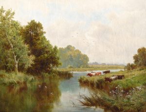 Cattle Grazing by a Riverbank